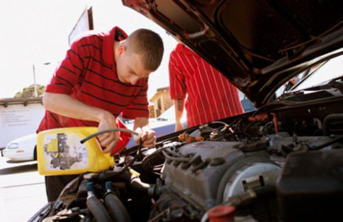 Teenager adding antifreeze to his car