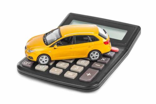 Calculator and toy car isolated on white background